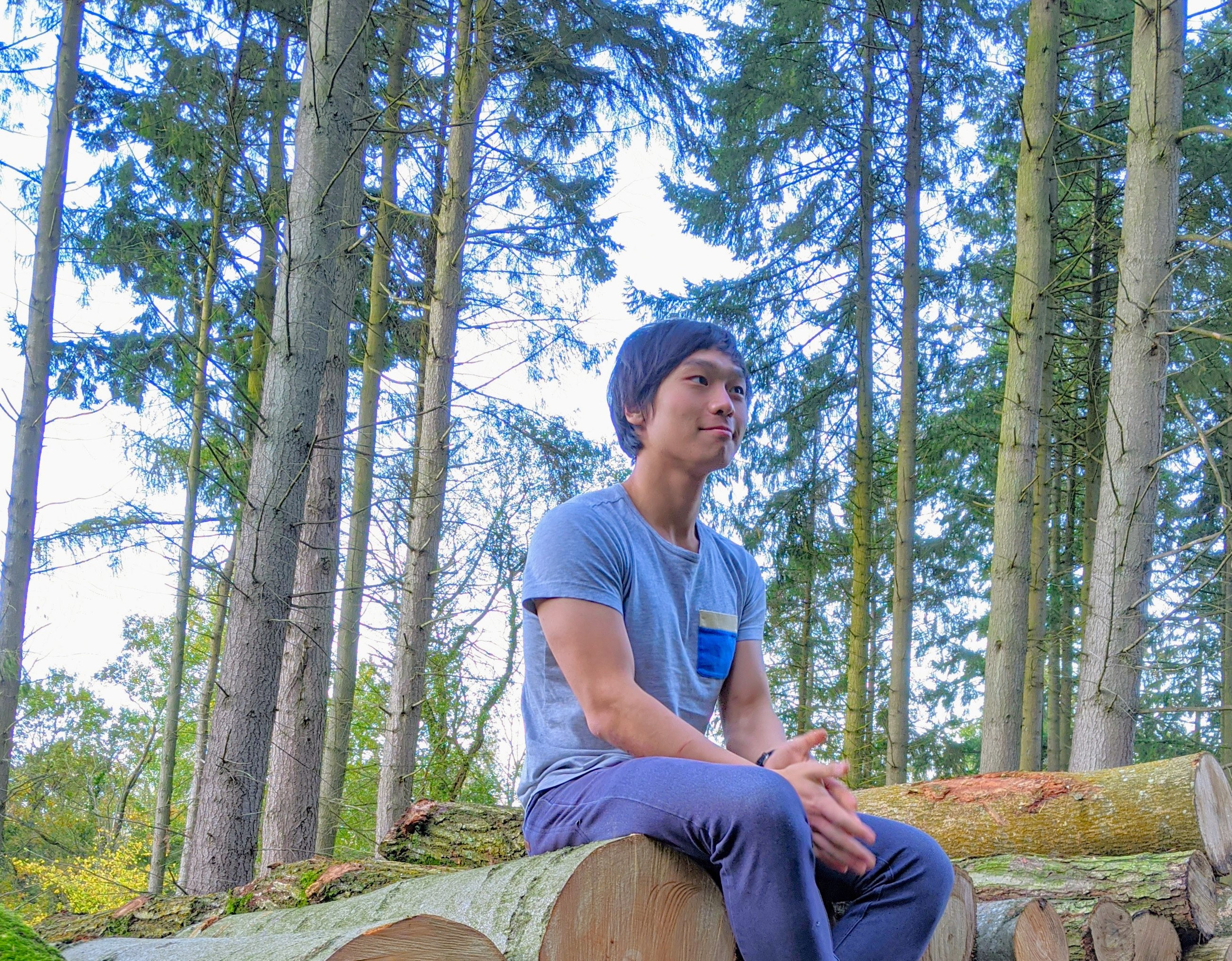 Photo of me sitting in a clearing in the forest